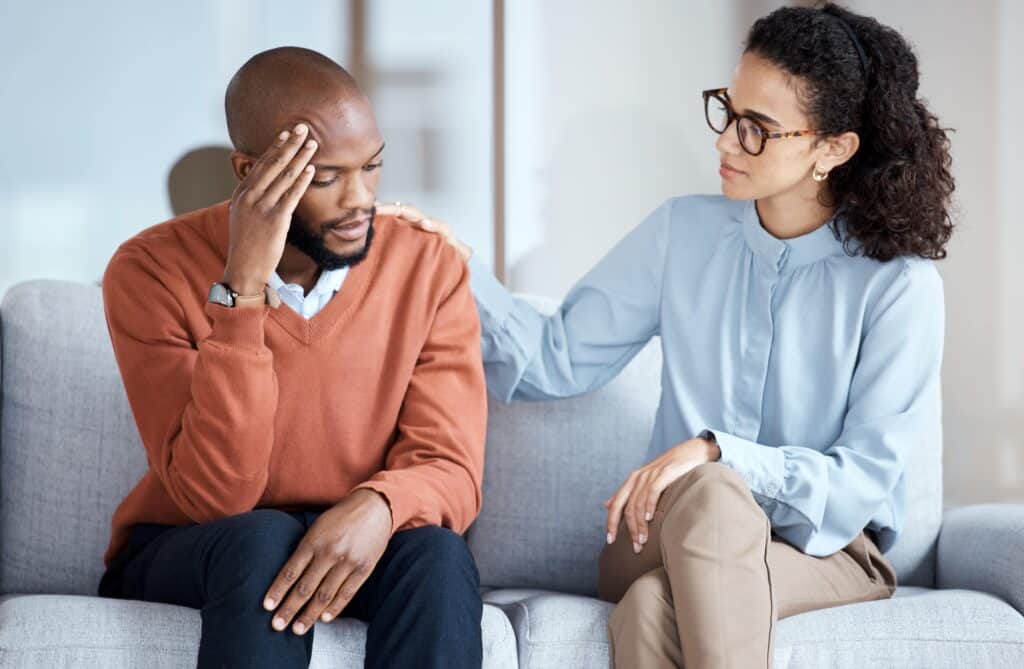 A man is comforted during grief counseling boca raton