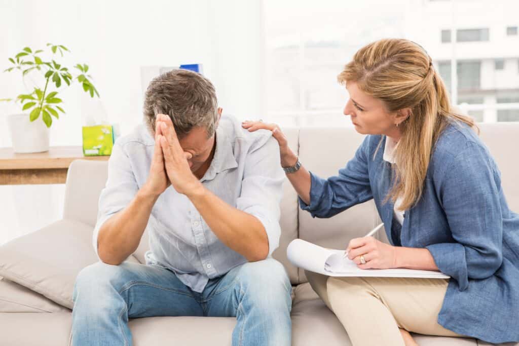 A man is comforted during grief counseling boca raton