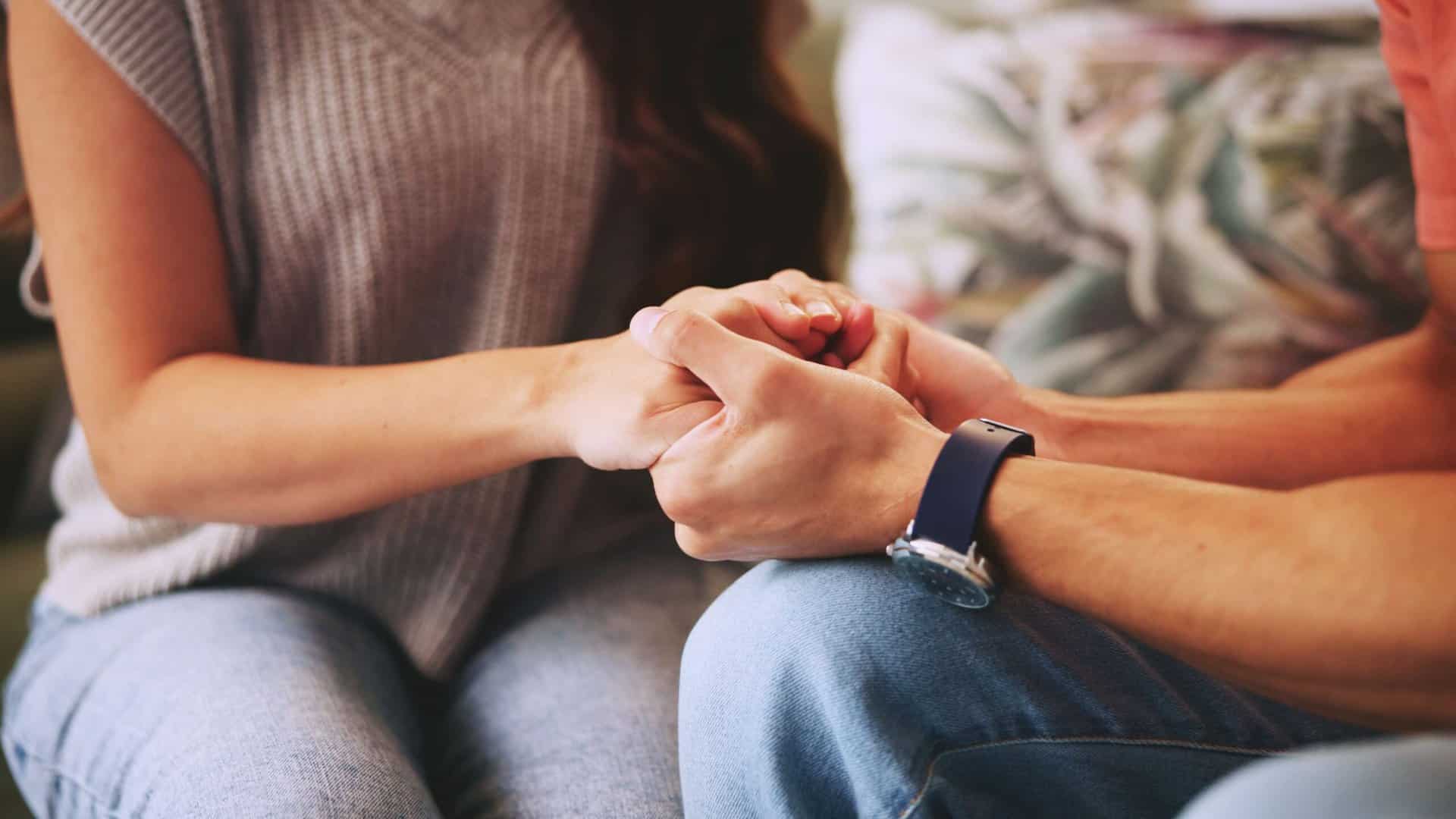 Couple holding hands during marriage counseling in Boca Raton.