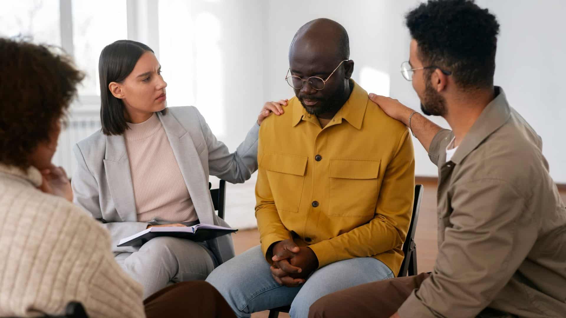 A man receiving peer support during PTSD treatment in Boca Raton.