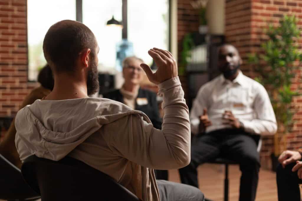 A man asks a question during therapists business development services