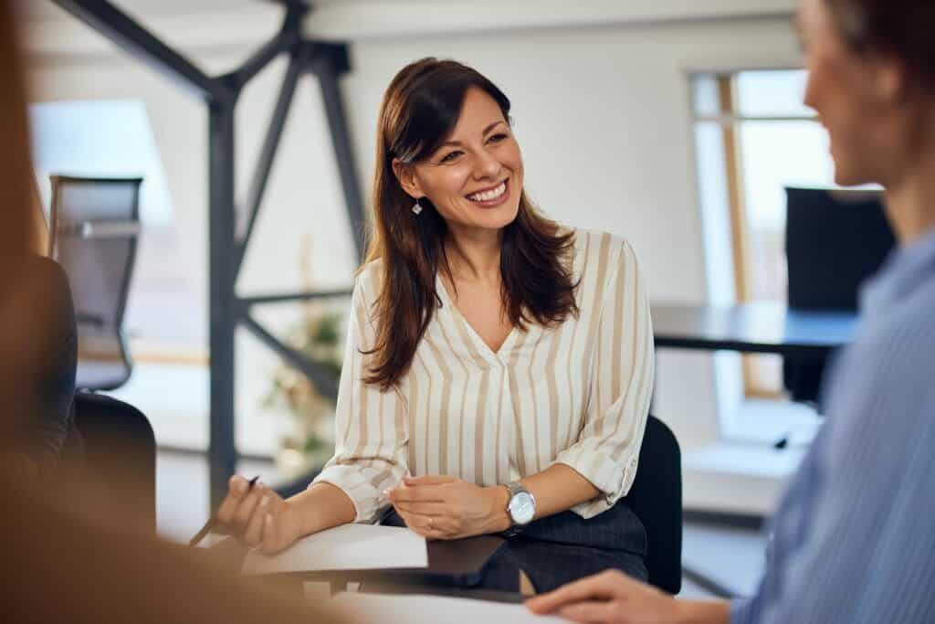 A woman discusses education consulting services boca raton with a group.