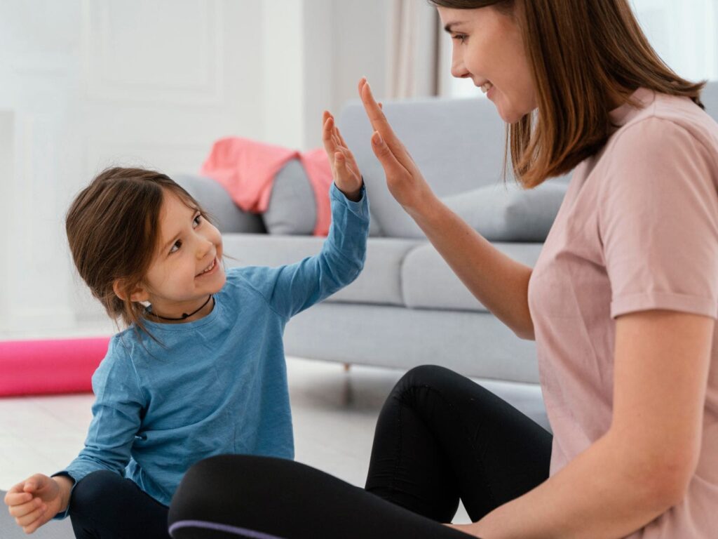 Mother high-fives her children.